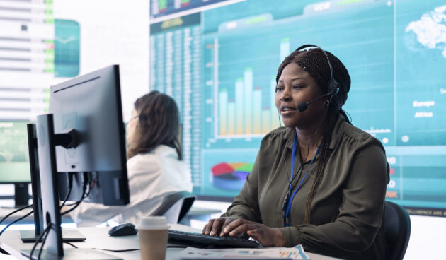 Woman sales manager verifies infographics plan in company coworking space Woman sales manager verifies infographics plan in company coworking space, works on creating business strategies and goals. Employee studying market dynamics and big data at workstation.